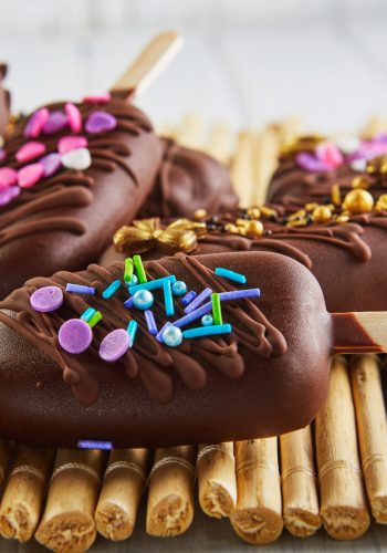 Pops cake in the form of chocolate ice cream with decoration.